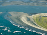 Acumulaci�n de sedimentos en la desembocadura de un r�o.